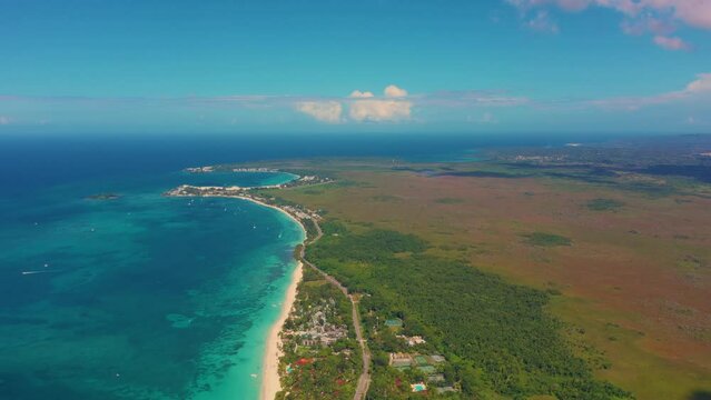 Aerial view of west coast of Jamaica. In the foreground - a Seven Mile Beach in Negril. The blue waters of the Caribbean Sea and the part of the island on which the shadow of the clouds falls. 