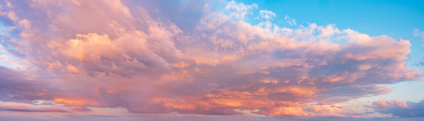 Naklejka na ściany i meble Beautiful panoramic sky with glowing clouds at sunset 