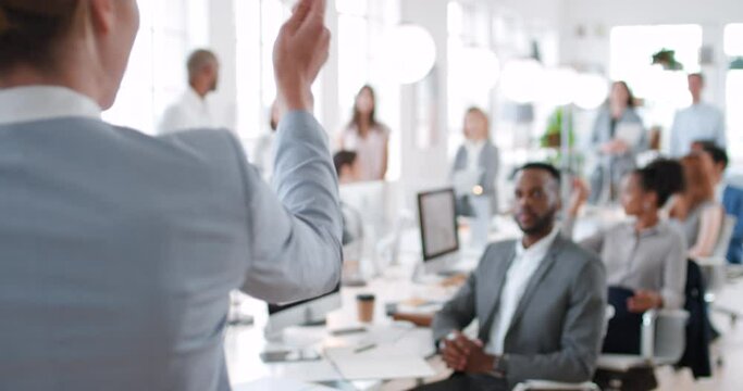 Presentation, speaker and hand of corporate business woman, coach or manager doing training, workshop and speaking to staff during meeting. Men and women in audience for asking questions during talk
