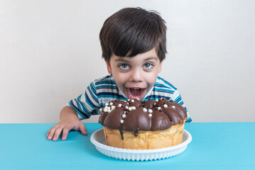 Cute adorable boy in studio eating chocolate cake