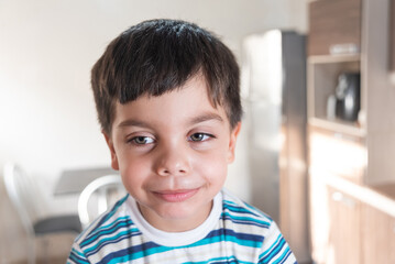 Fototapeta premium Cute and fun little boy in striped t-shirt