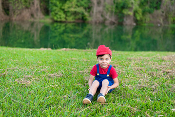 Cute boy in blue and red outfit in the park