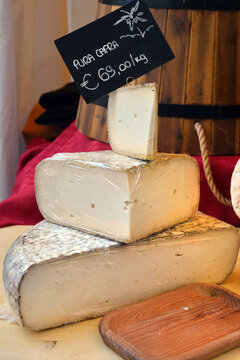 Italian food products, seasoned Goat cheese priced with pure goat written tag.