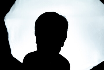 Cute adorable boy in the studio - silhouette