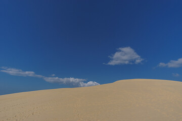 Sand dune and blue cloudy sky, Dune du Pilat, Arcachon, Nouvelle-Aquitaine, France