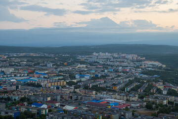Morning cityscape. Top view of the buildings and streets of the city. Residential urban areas at dawn. There is a volcano in the distance. Petropavlovsk-Kamchatsky, Kamchatka Krai, Far East of Russia.