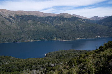 Fototapeta na wymiar View of the forest, blue water Gutierrez lake and Catedral hill in Bariloche, Patagonia Argentina.