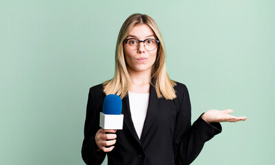 young pretty woman feeling puzzled and confused and doubting. presenter or journalist concept