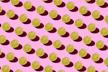 Lime pattern on a pink background. Pop art design, creative citruses. Yellow lemon, minimal flat style.