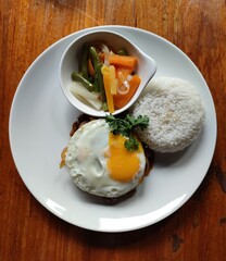 Salisbury steak with egg, rice, and vegetables