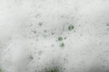 Fluffy soap foam as background, closeup view
