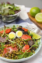 Plate of salad with mung beans on white marble table, closeup