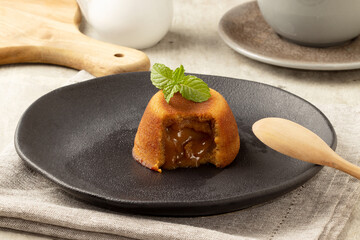 Delicious dessert petit gateau stuffed with dulce de leche in a plate.