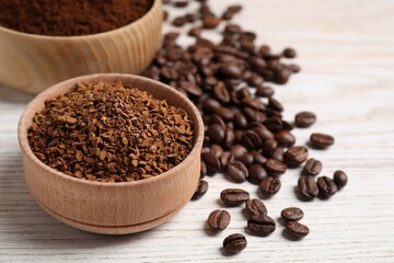 Different types of coffee on white wooden table, closeup