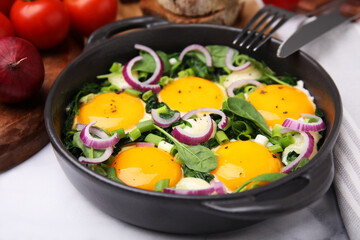Tasty Shakshouka served on white table, closeup