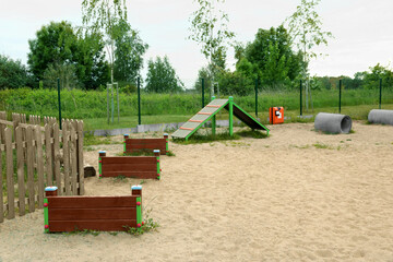 Wooden rover jump over, king of hill and doggie crawls on animal training area outdoors