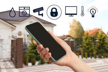 Woman using phone application for controlling smart home outdoors, closeup