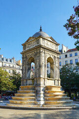 Fototapeta na wymiar Paris, France - Fontaine des Innocents, a public fountain on the place Joachim-du-Bellay in the Les Halles district in the 1st arrondissement of Paris. Image has copy space.