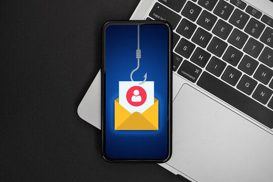 Phishing bait alert concept on a smartphone screen over a keyboard