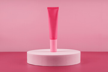 Pink cosmetic product on podium pedestal. Facial cream mockup on pink background, lotion in dispenser for woman skincare routine. Beauty moisturiser packaging. Lotion presentation mock up.