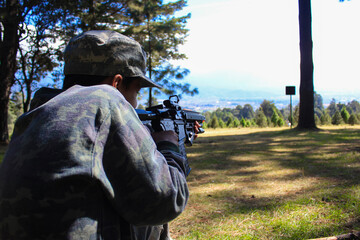 first person aiming assault rifle outdoor