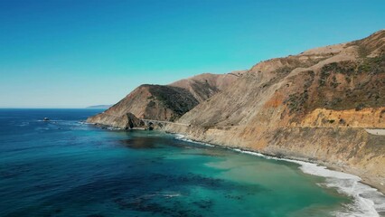 Drone shot along jaw-dropping landscape with mountains and ocean around. Postcard beauty of Pacific coastal landscape with crystal clear, azure waters. High quality 4k footage