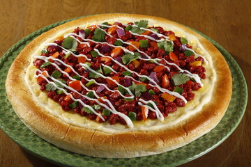 Filipino pork tocino pizza with tomato, bell peppers, onions and mayonnaise