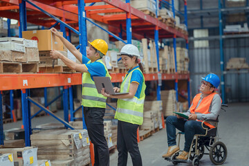 The supervisor is handicapped with a wheelchair inspecting the work background in warehouse.logistic  business export ,Warehouse worker checking packages on store