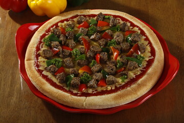 Unsliced pizza with whole beef chunks