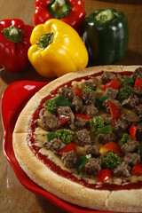 Unsliced pizza with whole beef chunks