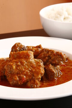 Filipino beef mechado - stew of beef chunks braised in tomato sauce with potatoes and carrots