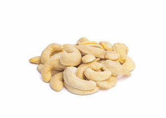 An image close-up isolated a dry cashew nuts stack heap is an ingredient food on the white background with clipping path.