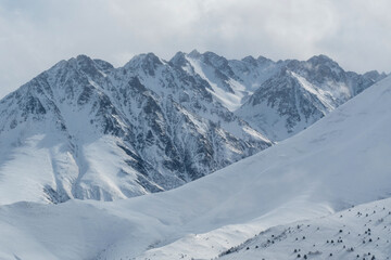 Fototapeta na wymiar Caucasian mountains on winter day. View from Kamunta village. Mountain Digoria, North Ossetia, Russia.