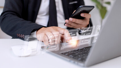 Fototapeta premium Paperless workplace ideas, e-signing, electronic signature, document management. A businessman signs an electronic document on a digital document on a virtual screen