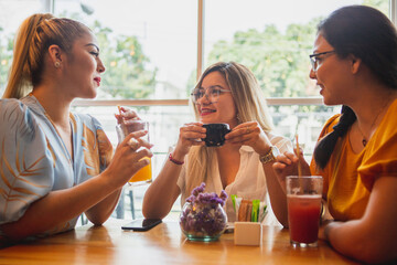 Three female friends drinking in a bar