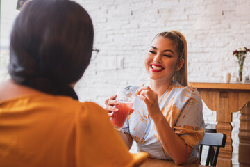 Two female friends chatting in a bar