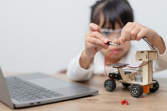 Asia Students Learn At Home In Coding Robot Cars And Electronic Board Cables In STEM, STEAM, Mathematics Engineering Science Technology Computer Code In Robotics For Kids Concept.