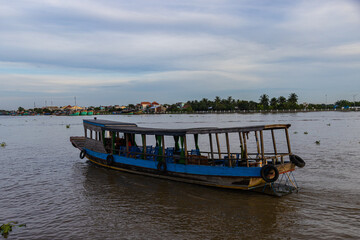 Ho Chi Minh City, Vietnam- November 9, 2022: Tourist boat at the river bank of the Mekong river at the Mekong Delta near Saigon. The Delta and Ho Chi Minh City is a famous travel destination