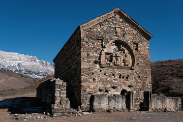 View of medieval Christian temple Tkhaba-Erdy on sunny winter day. Ingushetia, Caucasus, Russia.