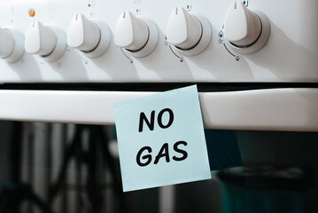 Inscription No Gas on sticker glued to gas stove panel in kitchen, close-up. Concept of energy...