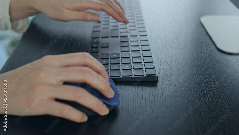 Poster close-up of a woman's hand using a desktop computer in the office.