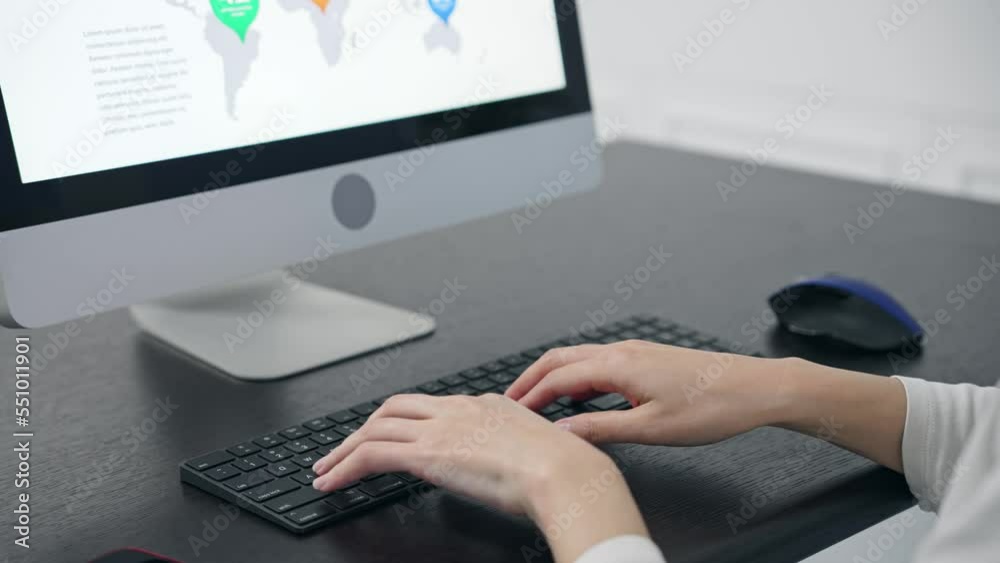 Poster close-up of a woman's hand using a desktop computer in the office.