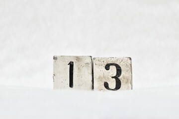 Unlucky number 13 calendar date, white winter background copy space