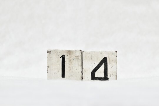 14 calendar date number, white snowy winter background copy space