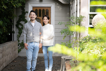 Portrait of an Asian couple taken in front of their house