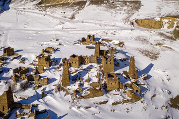 Drone view of ruins of old Ossetian settlement Lisri on sunny winter day. North Ossetia, Russia.