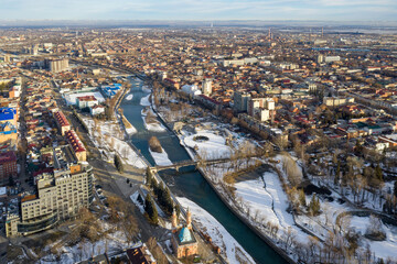 Fototapeta premium Drone view of Vladikavkaz and Terek river on sunny winter day. North Ossetia, Russia.