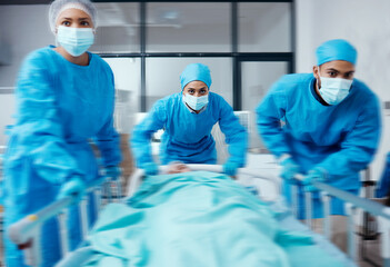 Surgery team, bed and rush in hospital, healthcare or patient emergency. Busy, medical staff or...