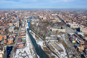 Naklejka premium Aerial view of Vladikavkaz and Terek river on sunny winter day. North Ossetia, Russia.