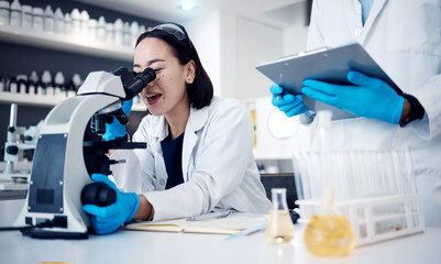 Microscope, scientist and woman with worker, research and medical cure in laboratory. Clipboard,...